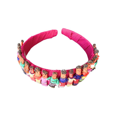 Pink headband with small figurines on a white background