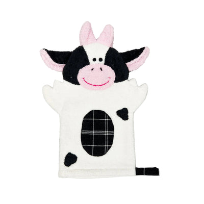 Cow-shaped plush toy on a marble background
